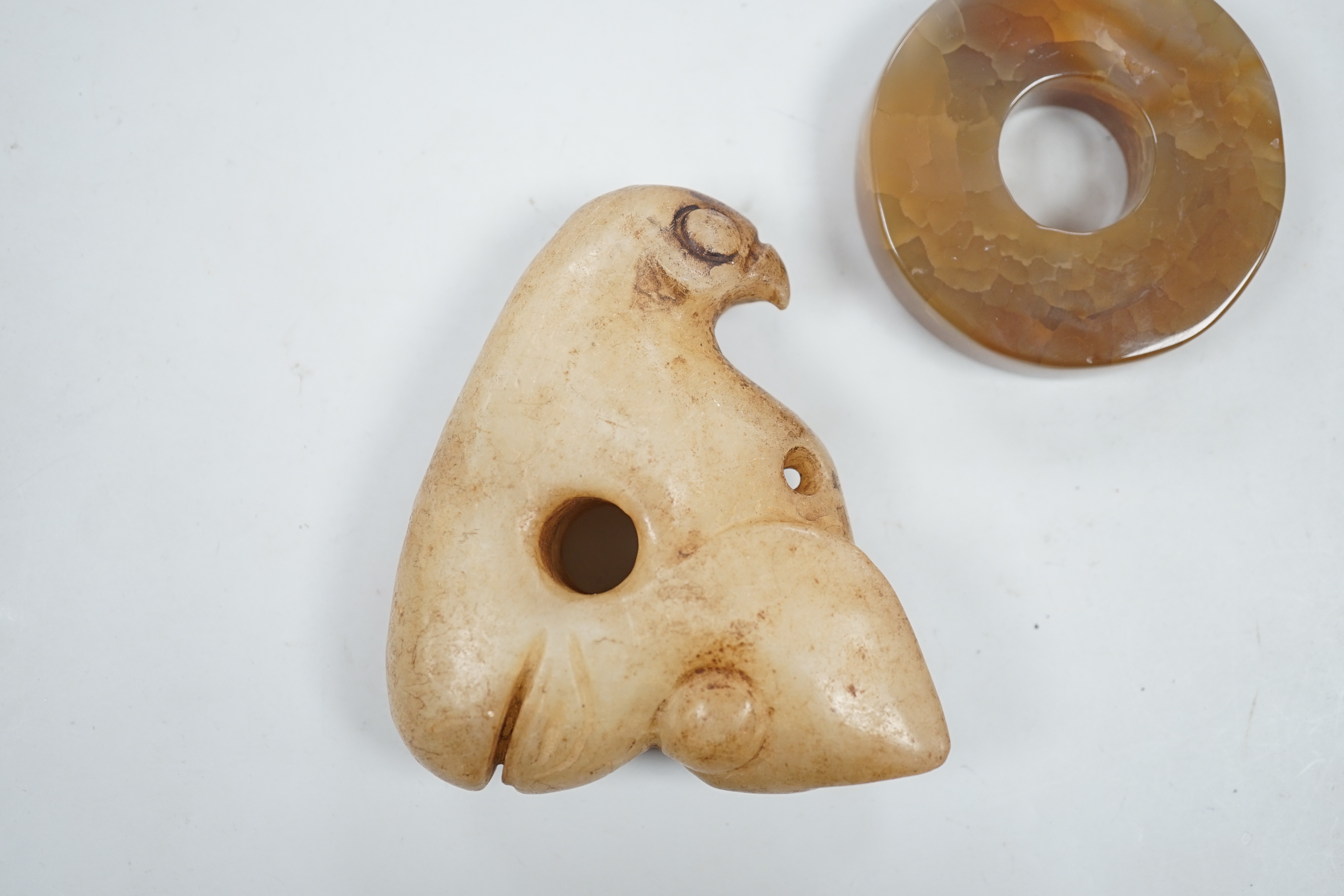 A Chinese agate bi disc and an archaistic jade eagle, 8.5cm